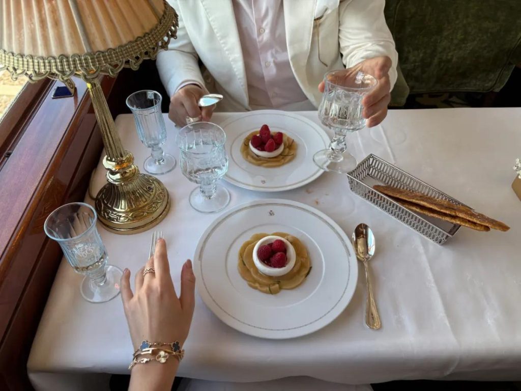 Lalique glass, crisp linens, and silver service